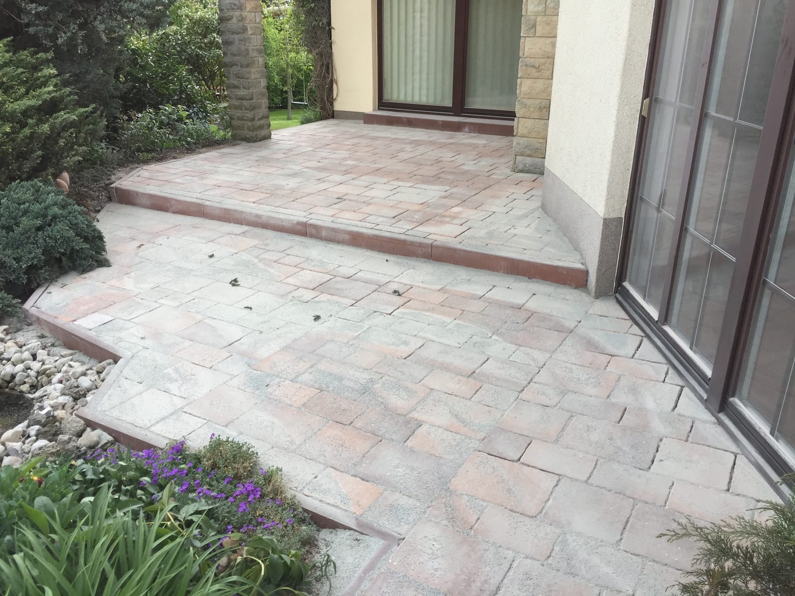 Paved terrace area with a step at the terrace door